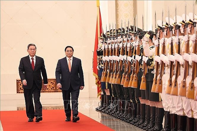 Thủ tướng Phạm Minh Chính và Thủ tướng Trung Quốc Lý Cường duyệt đội danh dự. Ảnh: Dương Giang/TTXVN