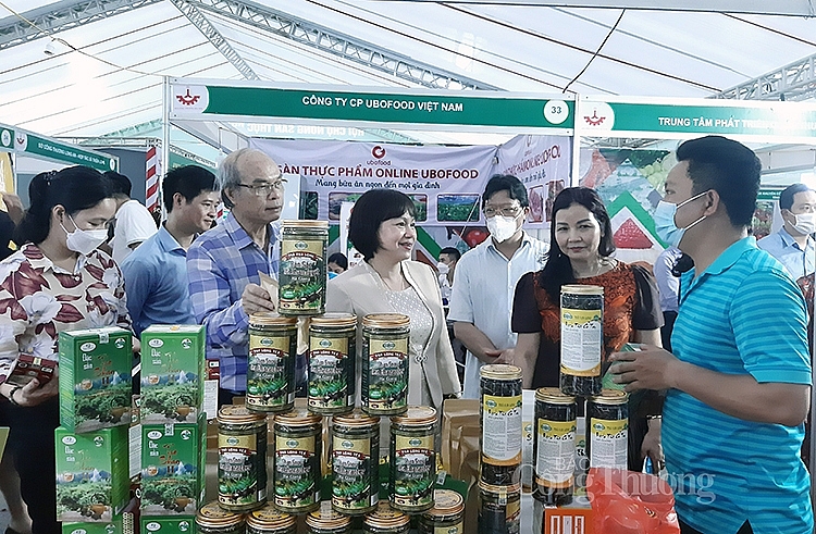 Ông Nguyễn Xuân Thành – Giám đốc Công ty TNHH Xuất nhập khẩu Vạn Long (áo xanh ngoài cùng bên phải) giới thiệu sản phẩm trà Shan Tuyết Hà Giang với đại biểu
